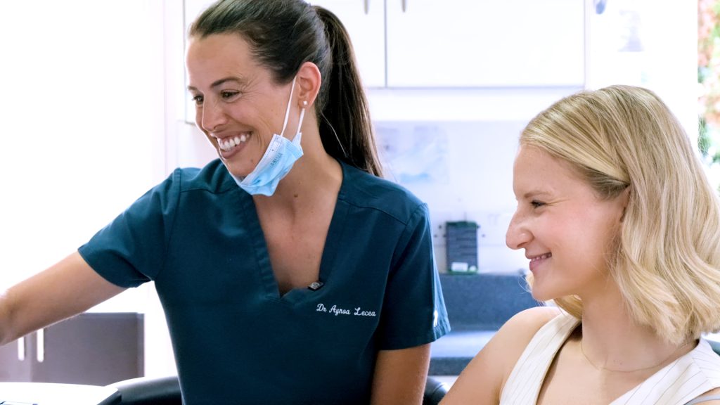 Integrative dentist Dr Aynoa Lecea with smiling patient - integrative dentistry