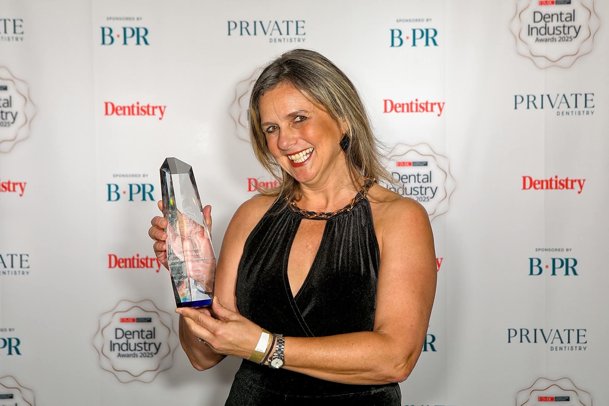 Woman holding a trophy.